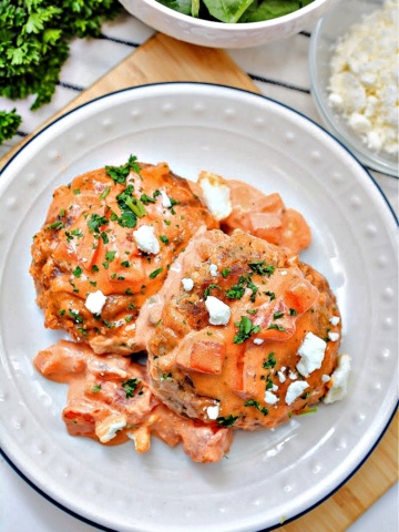 Two salmon burgers on a white plate