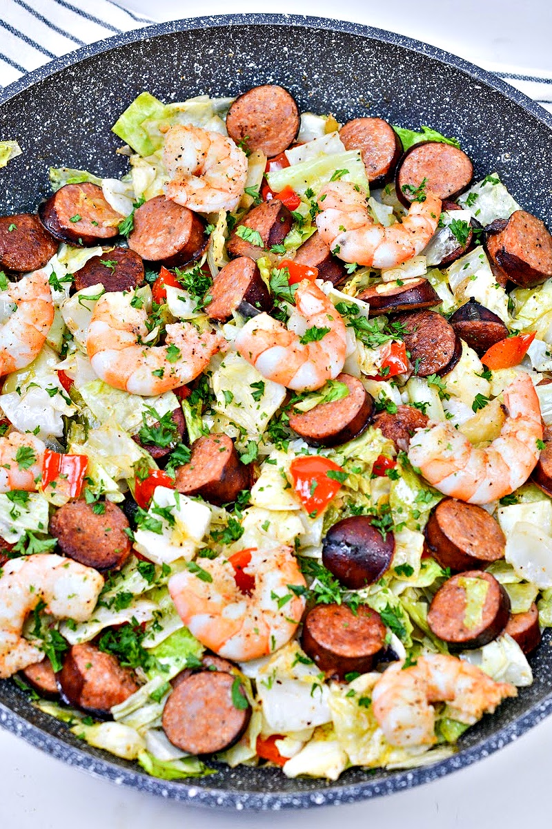 A skillet of shrimp, sausage and cabbage