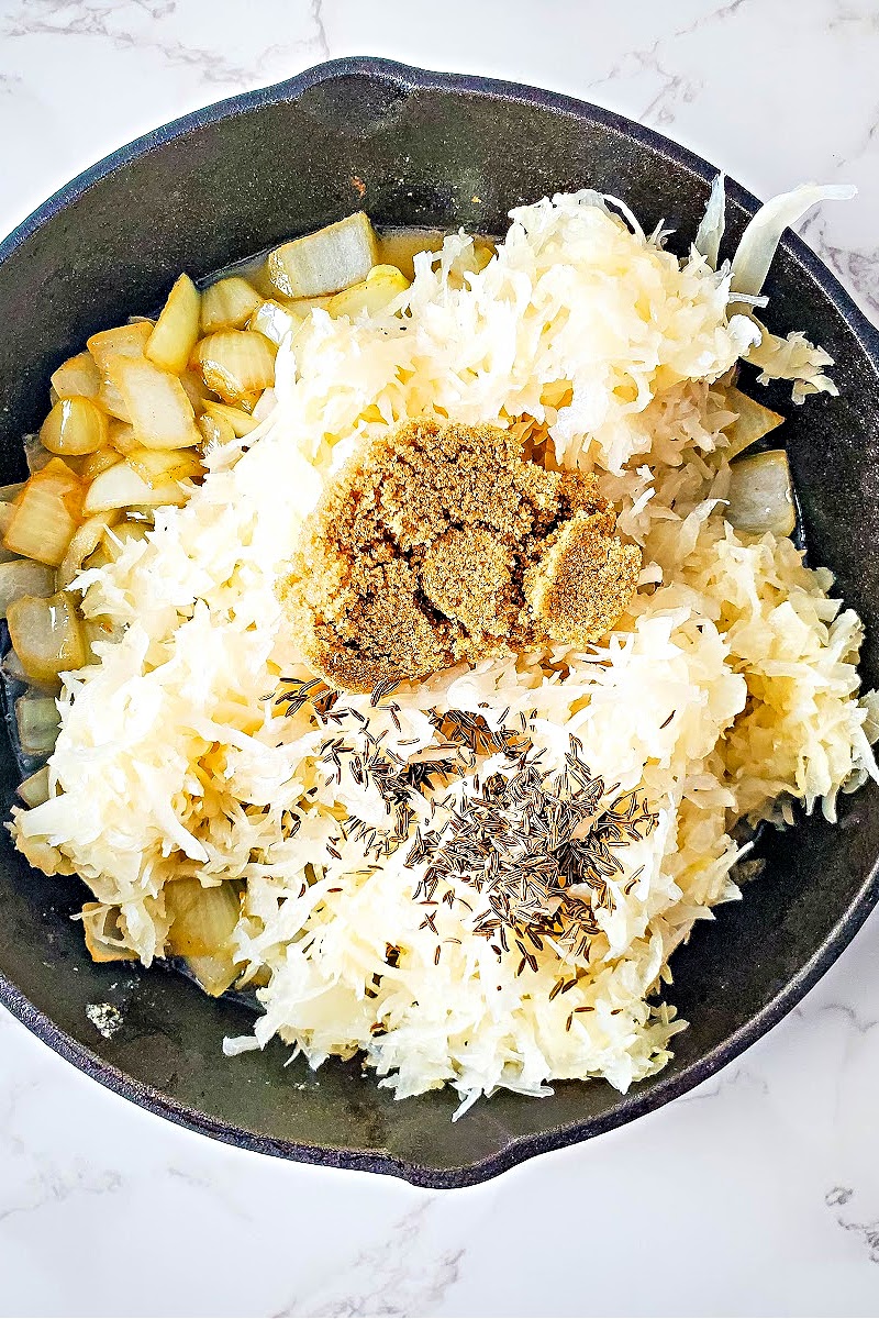 Brown Sugar substitute, sauerkraut, and onions in a skillet