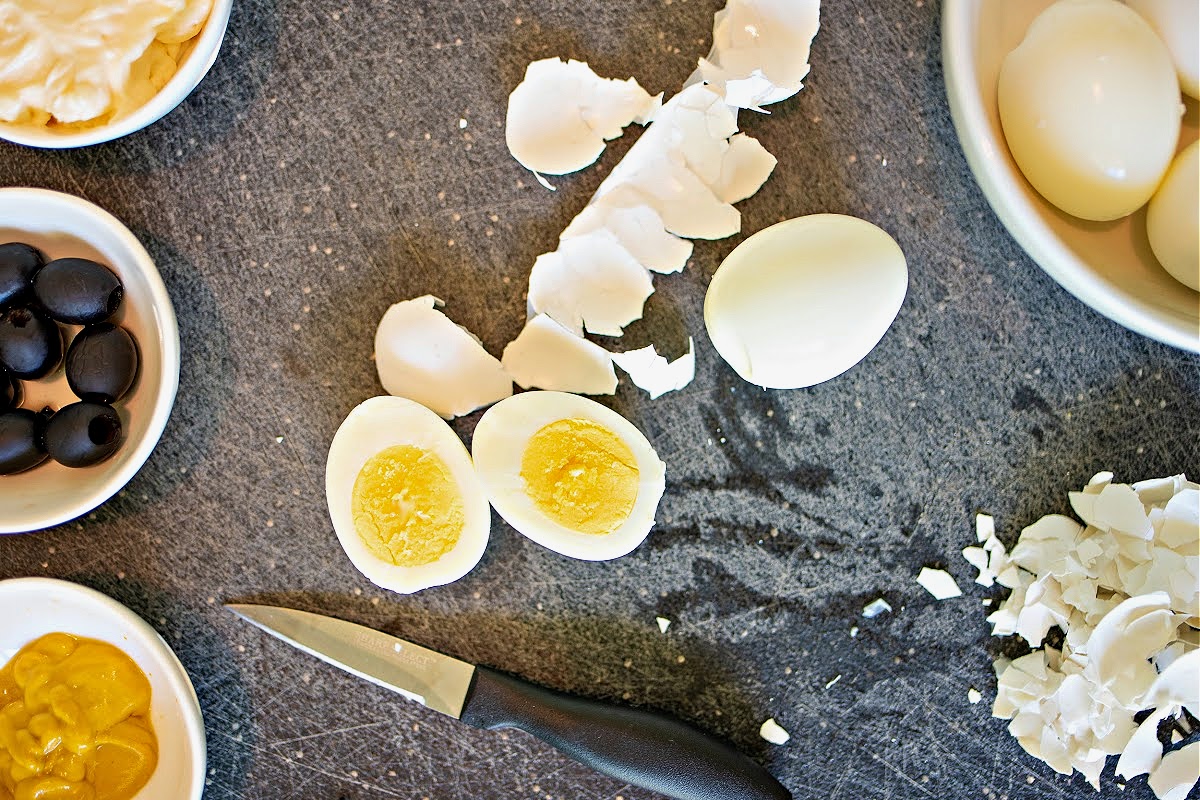 Slicing eggs to make deviled eggs