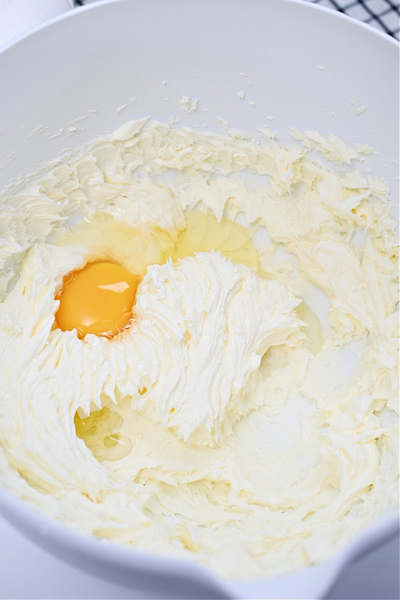 Adding eggs to the cake batter.