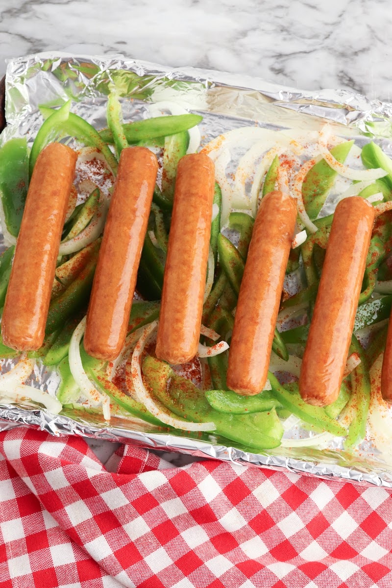 Uncooked sausages on a sheet pan