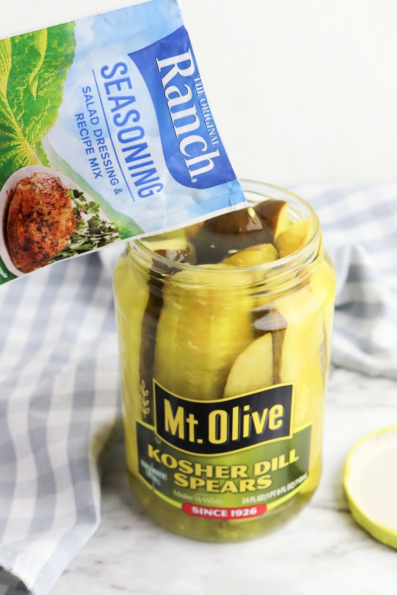Adding ranch seasoning to a jar of pickles